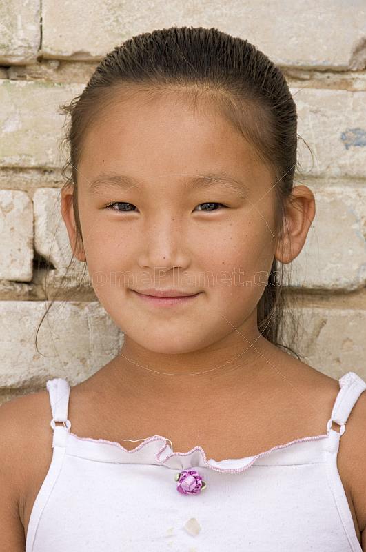 Young Mongolian girl in white dress.