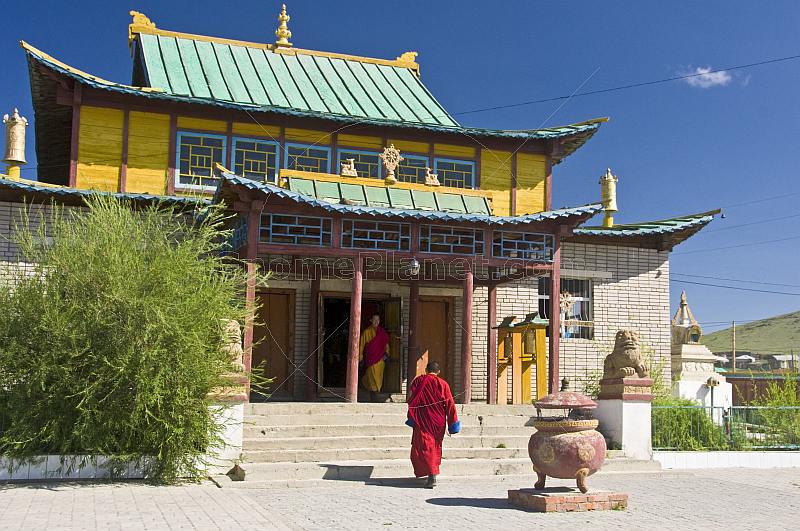 A Buddhist monk hurries to a service in the Gandan Muntsaglan Khiid monastery.