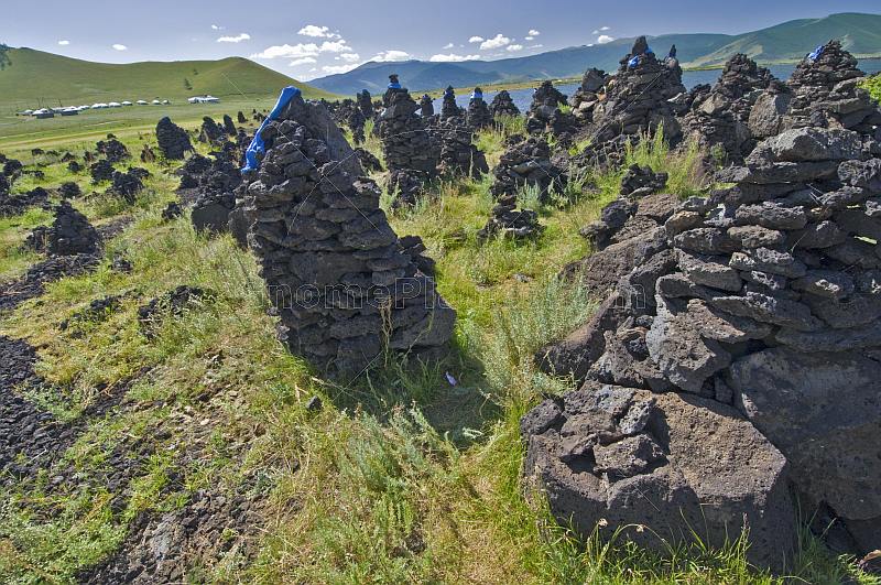 Shamanist volcanic stone mounds at the Terkhiin Tsagaan Nuur, the 'Great White Lake'.