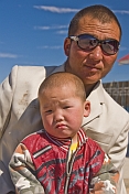 Mongolian shopkeeper and his son, photographed on a motorbike.