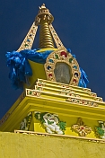 Yellow Dagoba with blue prayer scarves at the Singino monastery.