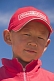 Small Mongolian boy in a red hat and jacket.
