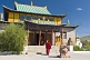 Image of A Buddhist monk hurries to a service in the Gandan Muntsaglan Khiid monastery.