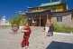 Image of A Buddhist monk carries food to a service in the Gandan Muntsaglan Khiid monastery.