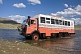 Image of A Dragoman Overland truck fords through a river.