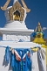 White and yellow Dagobas with blue prayer scarves at the Singino monastery.