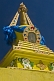 Image of Yellow Dagoba with blue prayer scarves at the Singino monastery.