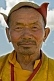 Mongolian carpenter in hat and traditional yellow jacket.