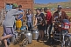 Image of Mongolian villagers filling water cans from a communal hose.