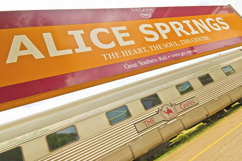 Great Southern Rail station signboard and Ghan train carriages at Alice Springs.