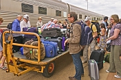 Passengers retrieve luggage at Alice Springs station
