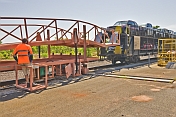 Attendant unloads vehicles from the car transporter carriage on the Ghan train.