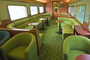 Tables and seating in the Red Gum Lounge Car of the Ghan long distance train.