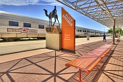 Camel memorial and Ghan train carriages at Alice Springs station.
