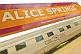 Great Southern Rail station signboard and Ghan train carriages at Alice Springs.