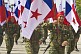 Smiling women soldiers from the Panamanian National Defense Forces carry the national flag of Panama.