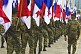 Soldiers of the Panamanian Defense Forces march along Avenida Balboa with the national Panamanian flag.