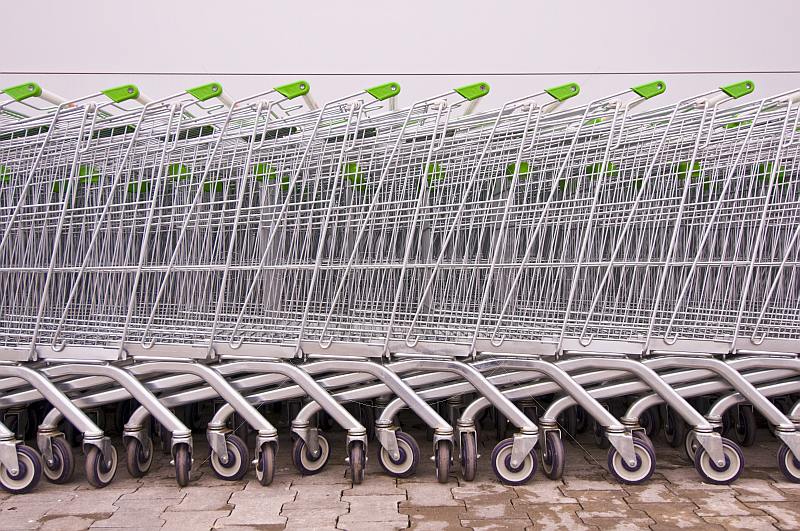 A line of supermarket shopping trolleys, outside a modern Russian supermarket.
