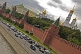 Traffic passes the red walls of the Kremlin, alongside the Moscow River.