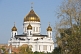 The gold-domed Cathedral of Christ the Saviour stands next to the Moscow River.