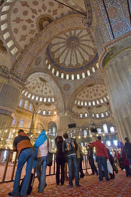 Tourist group views the domed interior of the Sultan Ahmet Camii, the Blue Mosque, in Sultanahmet.