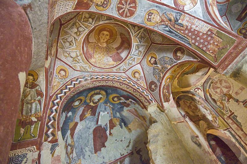 Desecrated Christian paintings in an ancient church carved out of a cave.