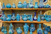 A display of local blue pottery jugs and plates in a cave workshop near Goreme.