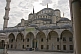 Courtyard, roof, and minaret of Sultan Ahmet\\'s blue mosque in Sultanahmet.
