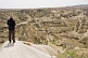 Image of A male tourist surveys the valley of caves near Goreme.