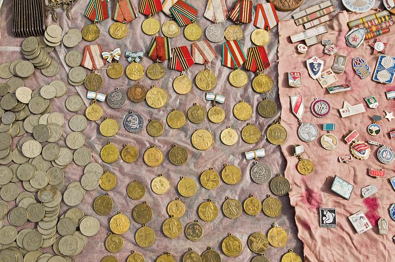 Coins, badges, and Soviet medals for sale at the Tolkuchka Bazaar.