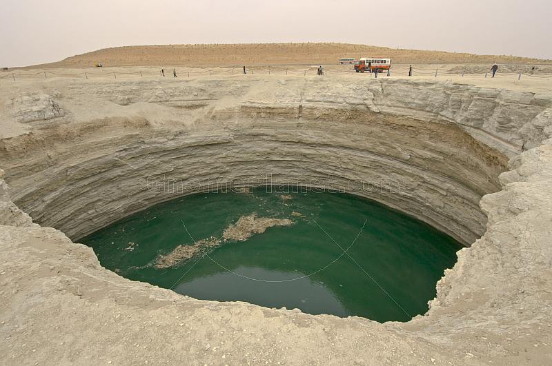 A Dragoman overland truck is dwarfed by the Darvaza Water Crater.