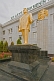 Golden statue of President Niyazov outside a government building.