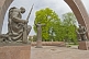 Statues of 2 kneeling soldiers guard the Soviet war memorial with its eternal flame.