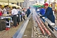 Men grill meat on long charcoal barbecue in Khreshchatyk Street.