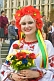 Ukrainian woman in national dress holds flowers on Independence Day.