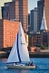Image of J-Class boat 'Whiplash' sails through Boston harbor in late evening.
