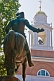 Image of Bronze statue of Paul Revere in front of city church.