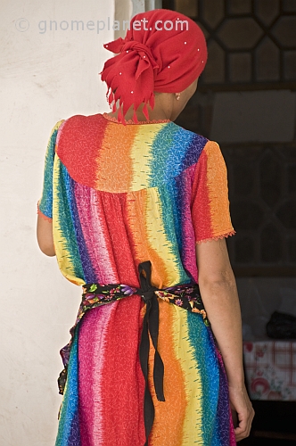 Bright colours of a dress worn by a lady trader in the bazaar.