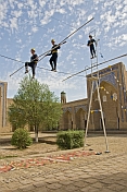 Circus Highwire Walkers perform in the courtyard of an old madrassa.
