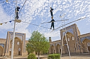 Circus Highwire Walkers perform in the courtyard of an old madrassa.