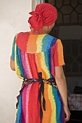 Bright colours of a dress worn by a lady trader in the bazaar.
