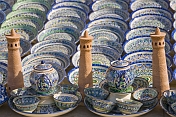 Ceramic minatures of the Kalon Minaret contrast the blues and greens of pottery bowls and plates.