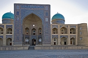 Blue domes and tiled frontage of the Mir-I-Arab Medressa.