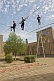 Image of Circus Highwire Walkers perform in the courtyard of an old madrassa.