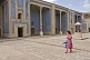 Young woman walks across the courtyard of the Tosh-Hovli Palace.