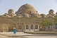 Woman in headscarf walks to the Hamam bathouse.