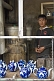 Image of Young man at a tea stall in the Fergana Valley organises teapots as he waits for the water to boil.