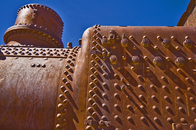 Closeup of boiler in rusting steam locomotive in the cemetery of steam engines.