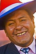 Smiling man in red white and blue hat.