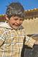 Image of Laughing Bolivian boy in check jacket.